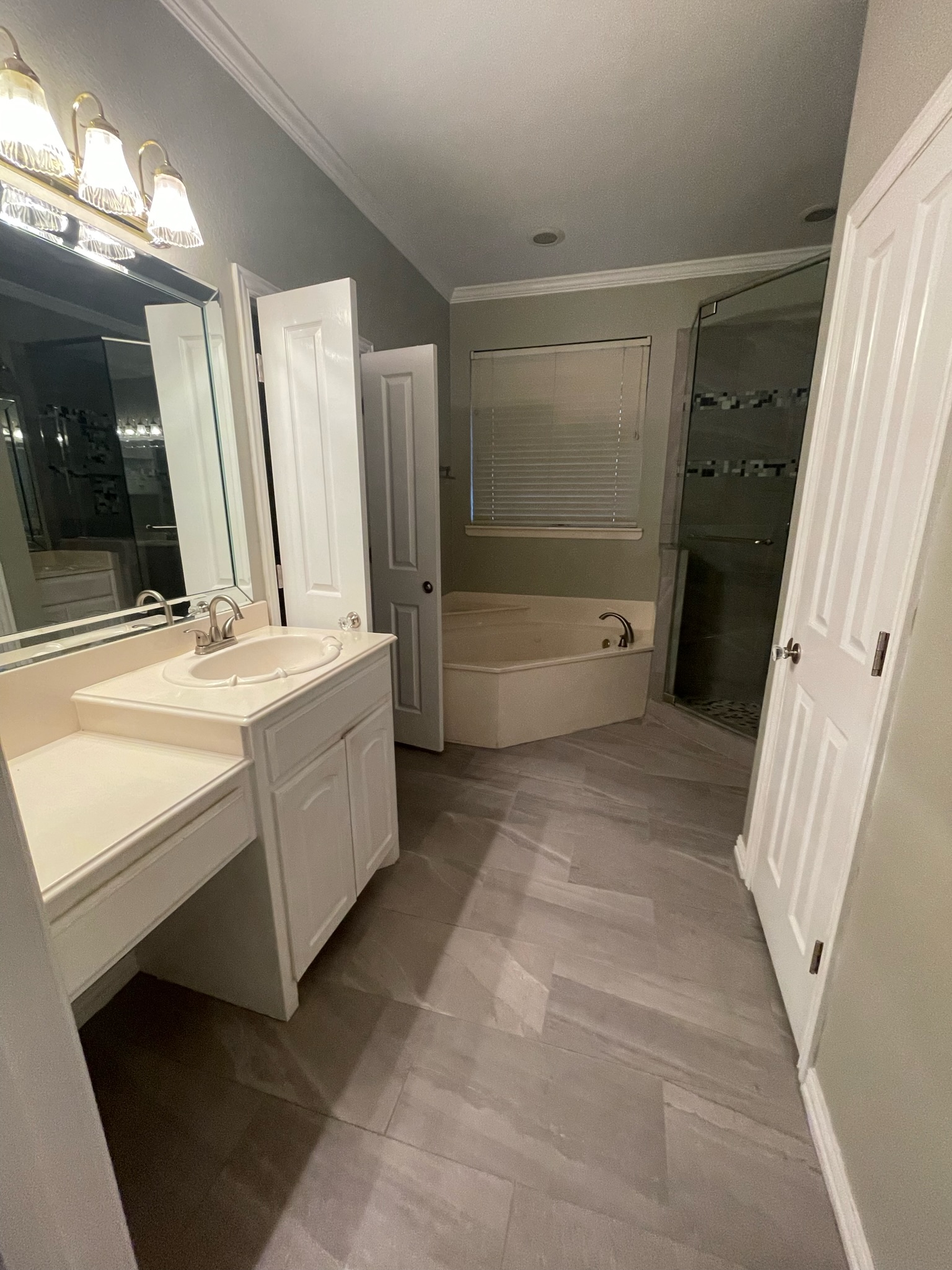Renovated master bathroom with modern tile and fixtures